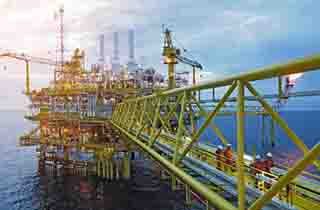 FRP grating walkways and cable management routes integrated into the steel framework of an offshore oil platform deck.